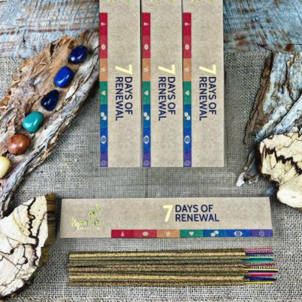 Product packaging for '7 Days of Renewal' Palo Santo incense with natural elements on a textured surface.