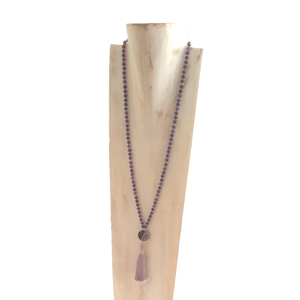 Handmade Refocusing Mala Necklace – Amethyst - Necklace with purple beads and a tassel on a wooden stand against a white background