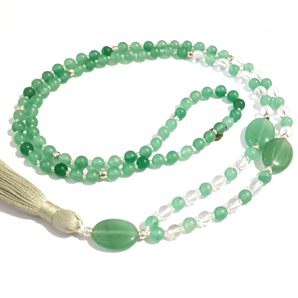 Handmade Green Aventurine and Quartz Good Fortune Mala necklace curled on table