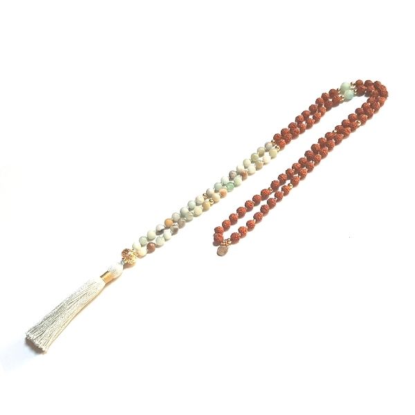 Handmade Amazonite and Rudraksha Arogita Mala necklace with gold filigree guru bead looped on table 