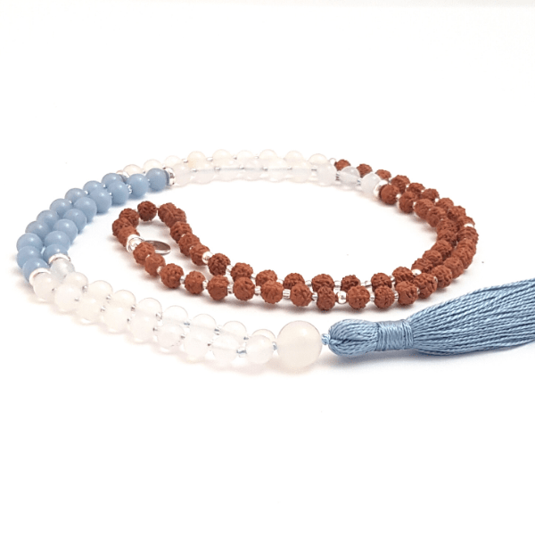 Handmade Angelite, White Agate and Rudraksha Angel Mala necklace curled on table