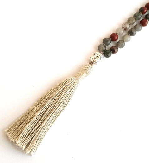 Close up of Handmade Bloodstone Empowering mala necklace with Buddha head guru bead