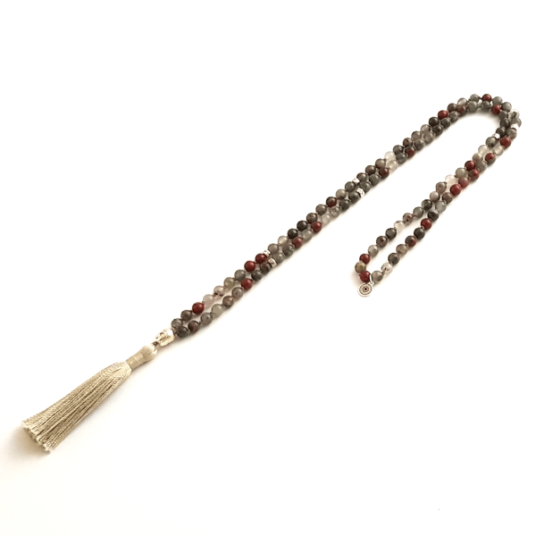 Handmade Bloodstone Empowering necklace mala with Buddha head guru bead looped on table