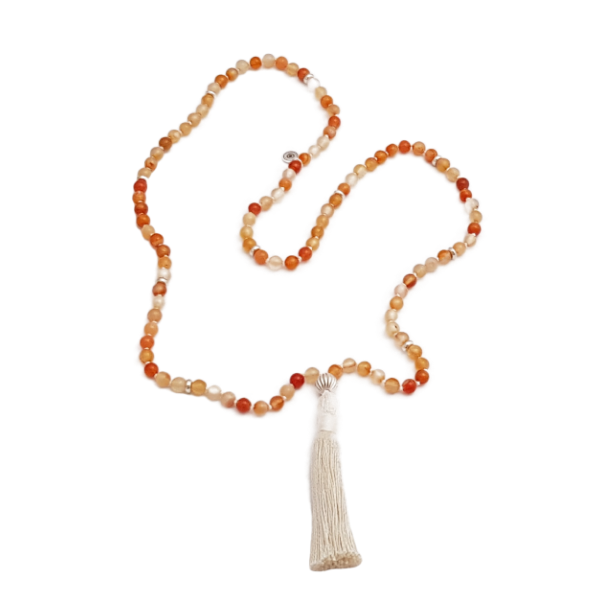 Handmade Carnelian Sacral Chakra Mala necklace laid loosely on table