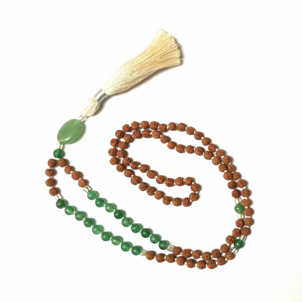 Handmade Green Aventurine and Rudraksha Prosperity Mala Necklace looped on a table