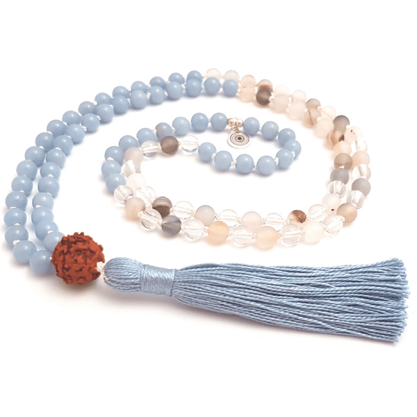 Handmade Throat Chakra Mala – Angelite, Quartz, Agate & Rudraksha necklace curled on table