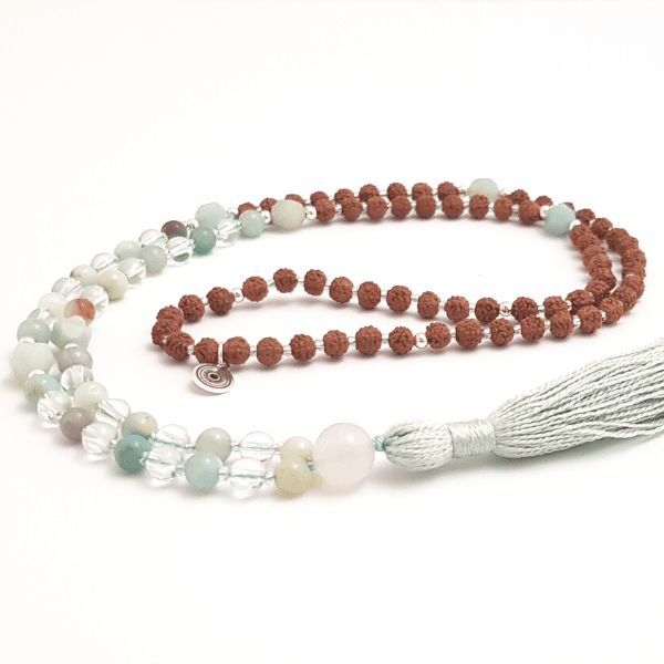 Handmade Affirmation Mala Necklace – Amazonite, Quartz & Rudraksha curled on white table