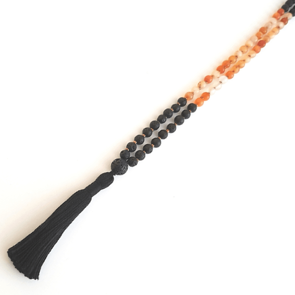 Close up of handmade Creativity Mala Necklace – Carnelian & Lava for Passion & Energy tassel and beads