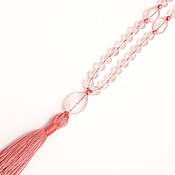 Close up of handmade Rose Quartz Mala Necklace – Love, Healing & Heart Chakra Energy tassel and guru bead