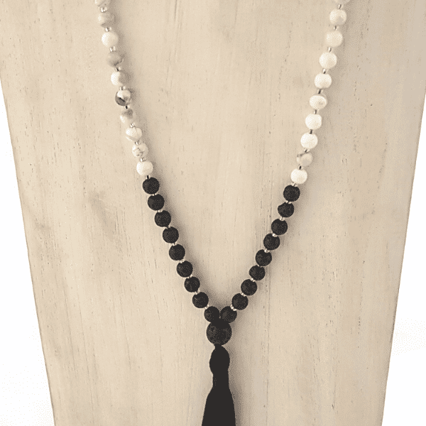 Close up of Handmade Serenity Mala Necklace – Howlite & Lava Stone for Calm & Grounding on jewellery bust