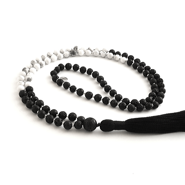 Handmade Serenity Mala Necklace – Howlite & Lava Stone for Calm & Grounding  curled on table