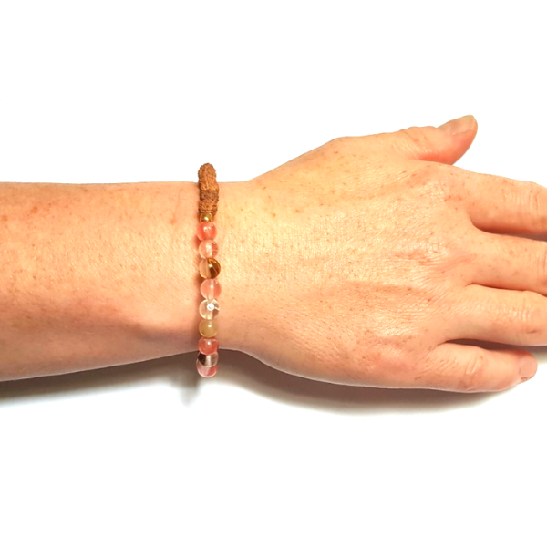 Woman's wrist wearing Harmonising Tourmalinated Quartz and Rudraksha Handmade Bracelet
