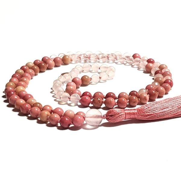 Handmade Rhodochrosite and Rose Quartz Heart Chakra Mala necklace curled on table
