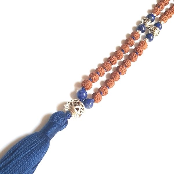 Close up of handmade Rudraksha and Lapis Lazuli Insight Mala necklace with silver filigree guru bead