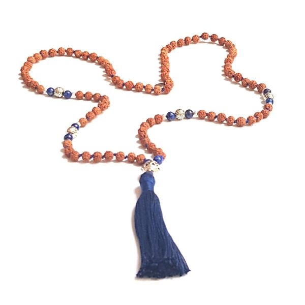 Handmade Rudraksha and Lapis Lazuli Insight Mala necklace with silver filigree guru bead loosely laid on a table