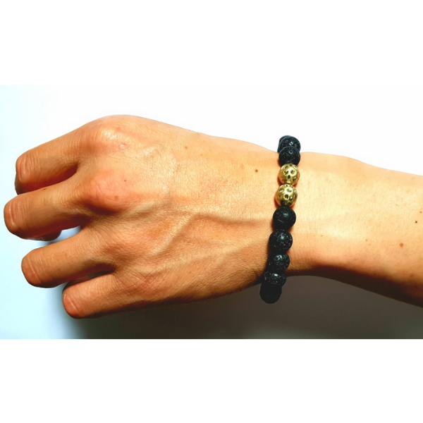 Man wearing handmade Lava Bead Rebalancing Bracelet with two Gunmetal centerpiece beads on wrist 