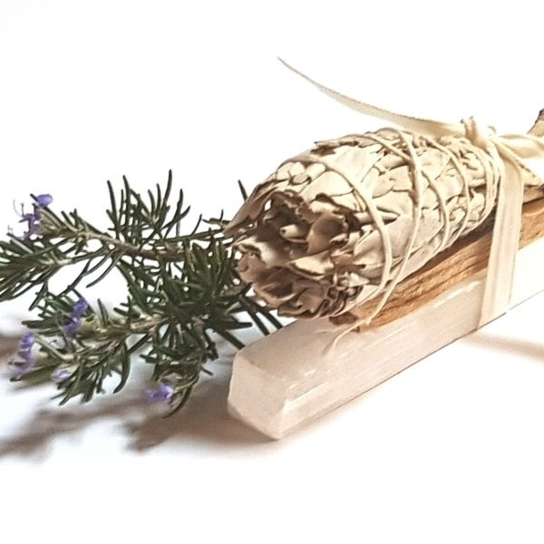 Smudging kit with white sage, selenite and Palo Santo with Rosemary sprig in background