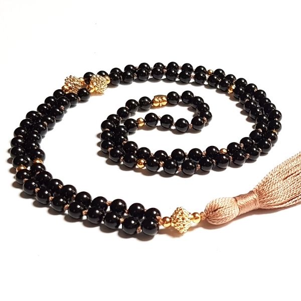 Handmade Black Tourmaline Protection Mala  necklace curled on table