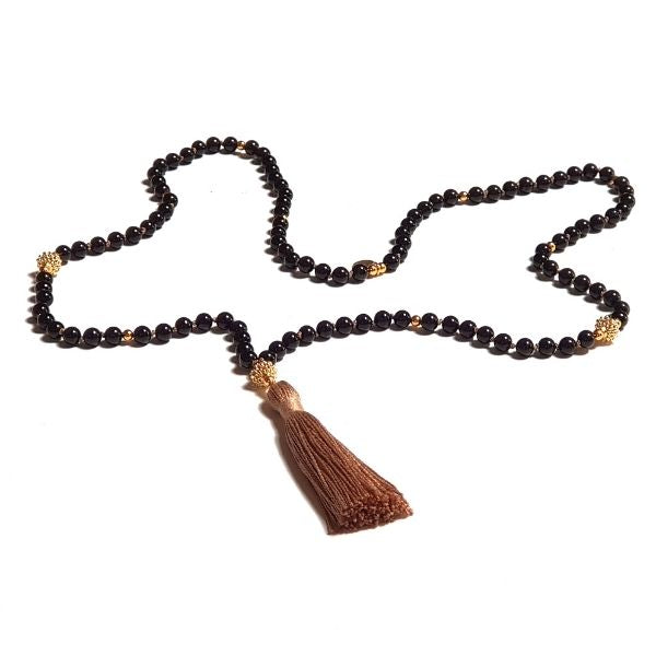 Handmade Black Tourmaline Protection Mala necklace loosely laid on table