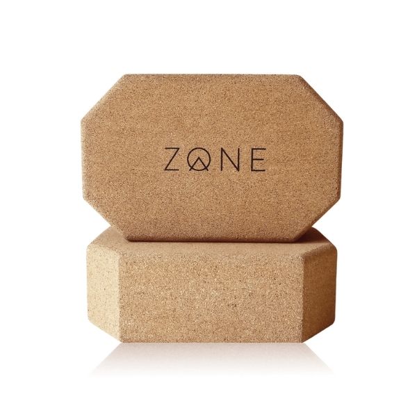 Two cork Zone yoga rectangular blocks with corners cut at an angle balanced one on top of each other