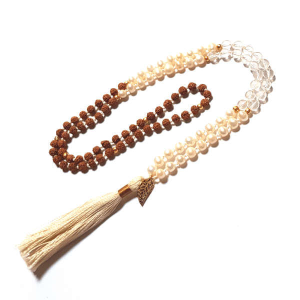 Handmade Wisdom Mala – Freshwater Pearls, Quartz & Rudraksha Beads necklace with leaf charm on tassel  looped on table