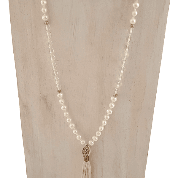 Close up of handmade Wisdom Mala – Freshwater Pearls, Quartz & Rudraksha Beads with leaf charm on tassel  on jewellery bust