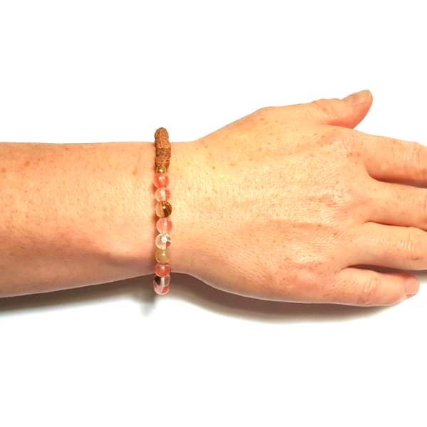 Woman wearing Handmade Harmonising Bracelet – Tourmalinated Quartz & Rudraksha for Peace on white background