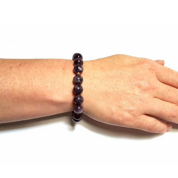 Woman wearing Handmade Refocusing Bracelet – Handmade Amethyst & Crown Chakra Crystal Bracelet on wrist