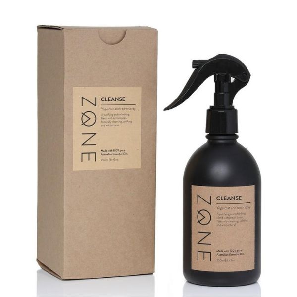 Zone black glass spray bottle of yoga mat cleaner next to brown kraft product  box 
